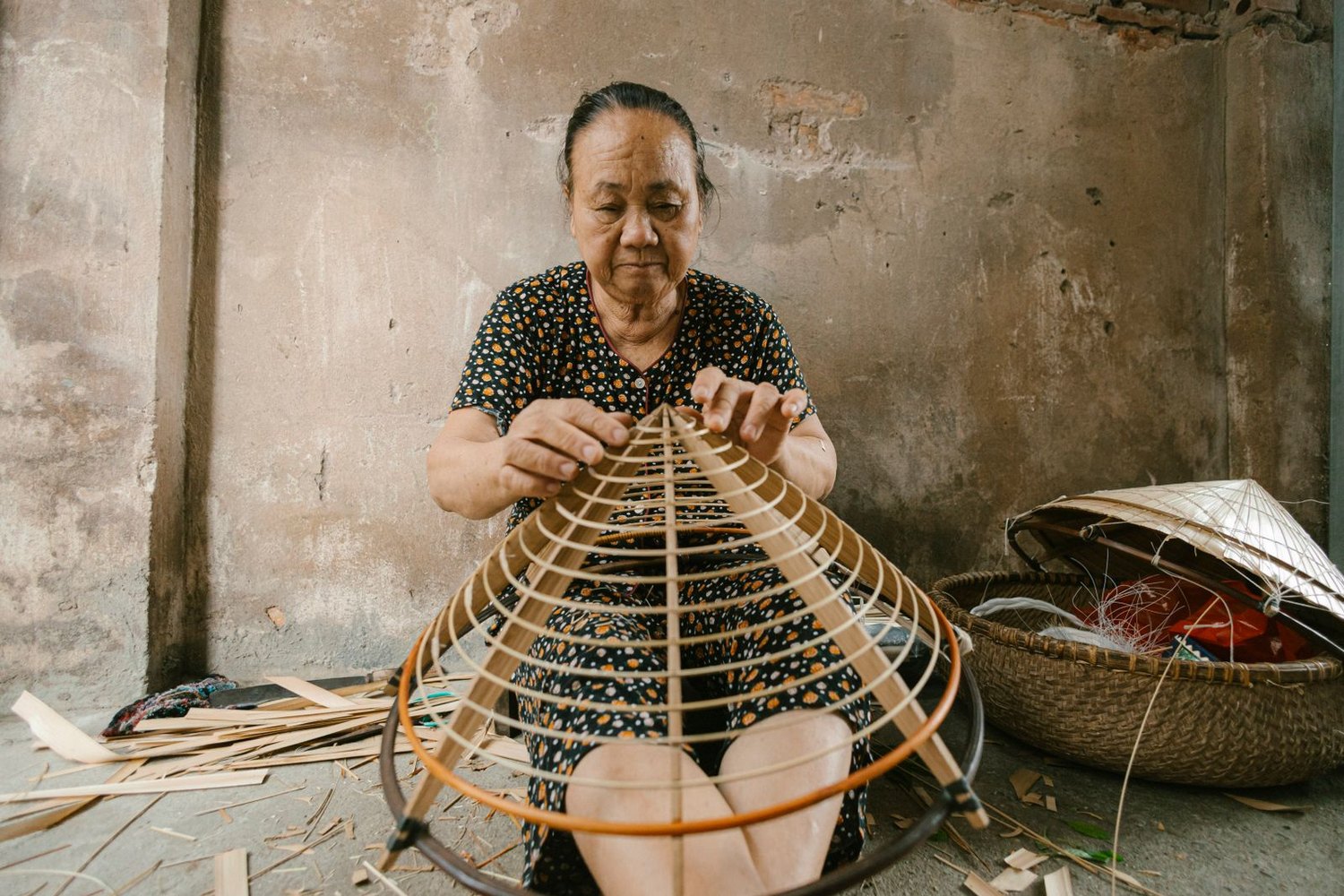 Artisan handcrafting a traditional woven hat by hand