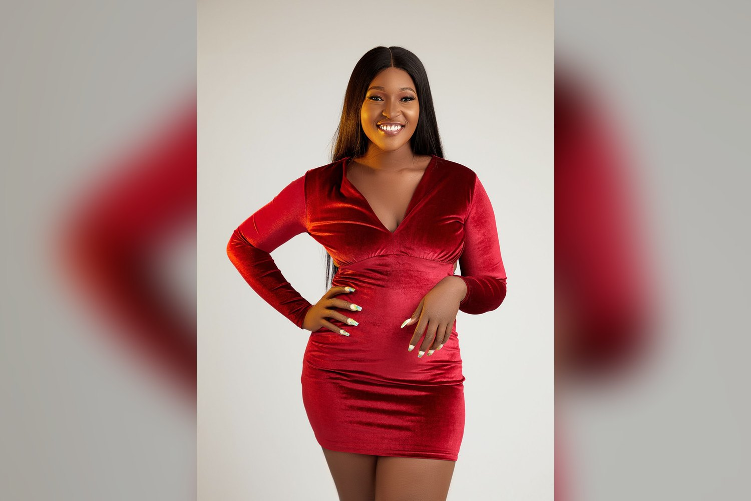 Smiling woman in a red velvet holiday dress
